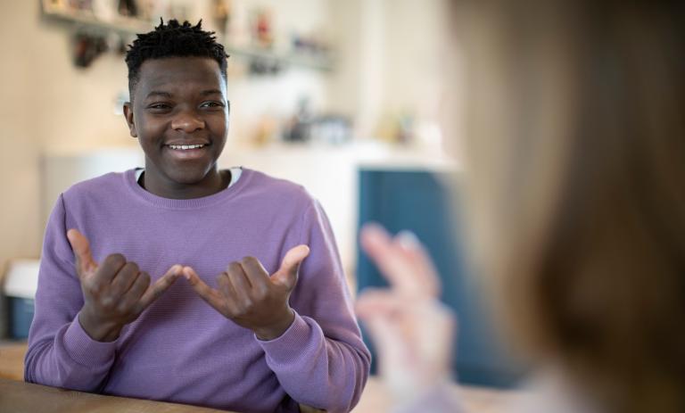 A youth having a conversation in sign language