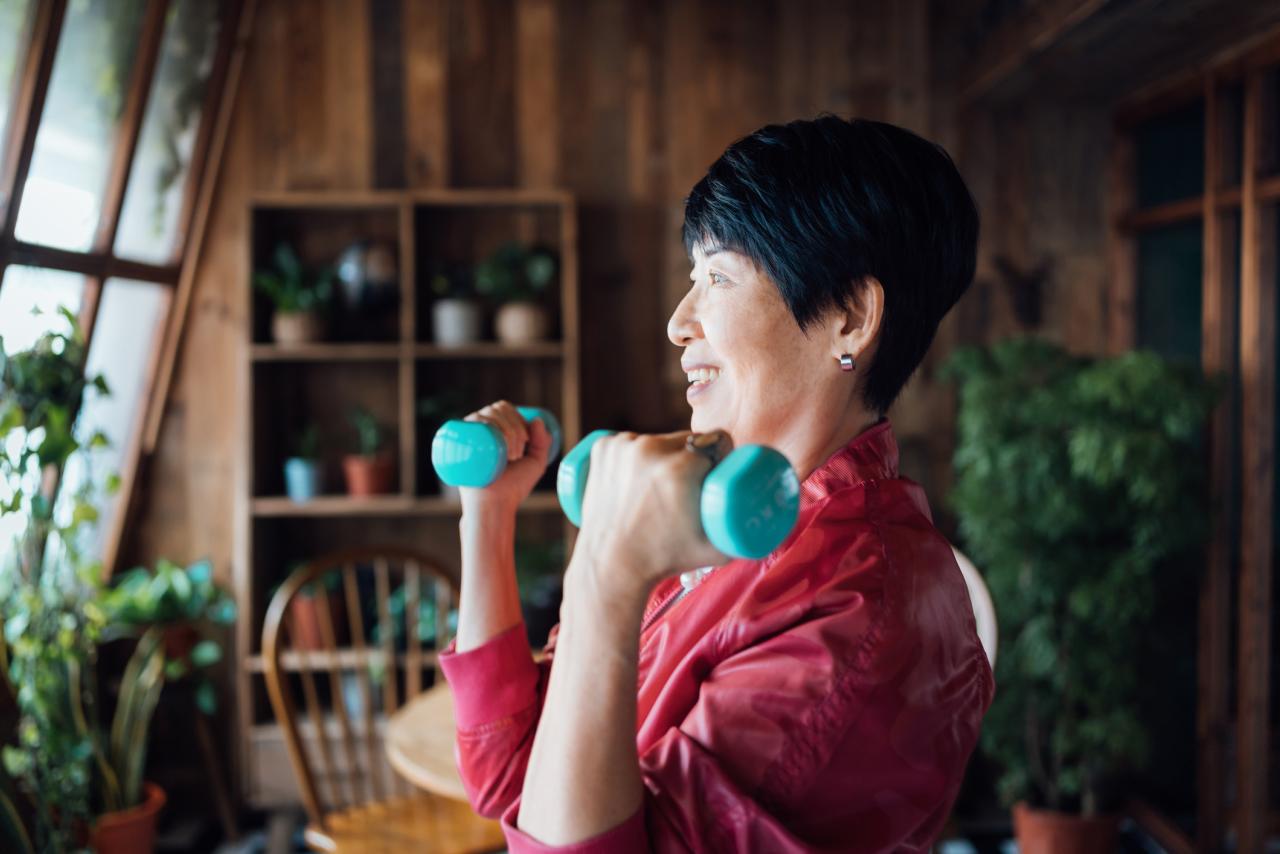 A person exercising at home using light weights.