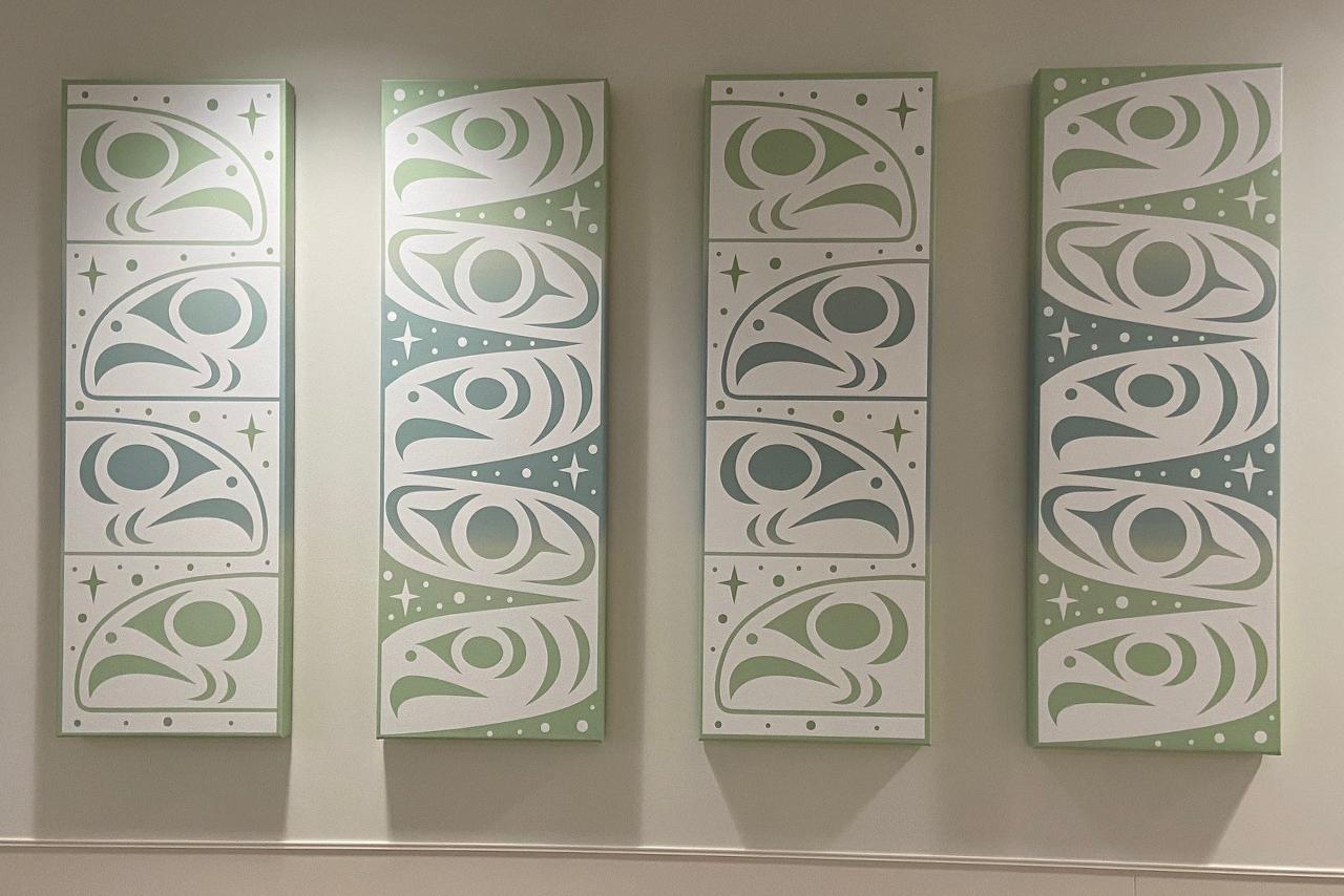 4 Indigenous artworks in a row mounted on a wall 