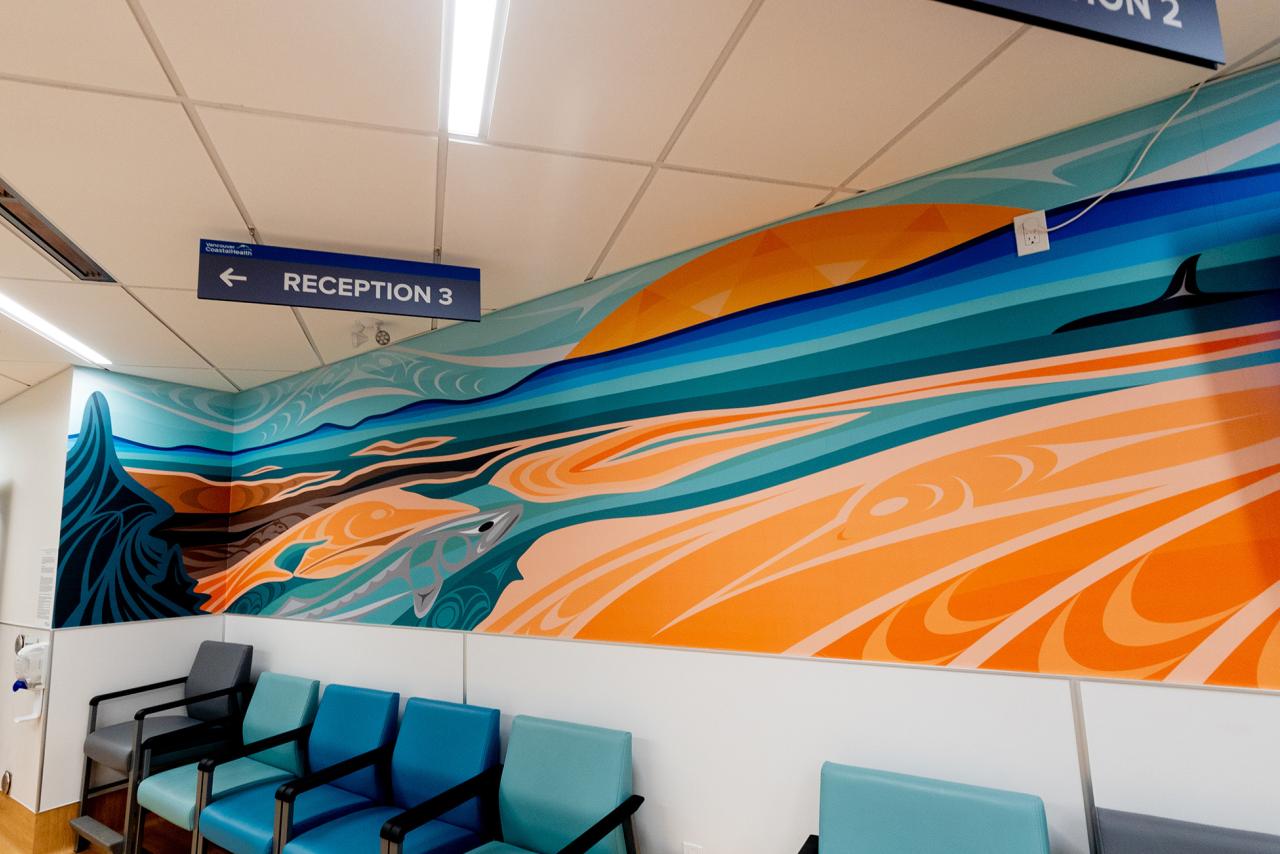 Mural on wall in medical building of a salmon and orca whale in the ocean