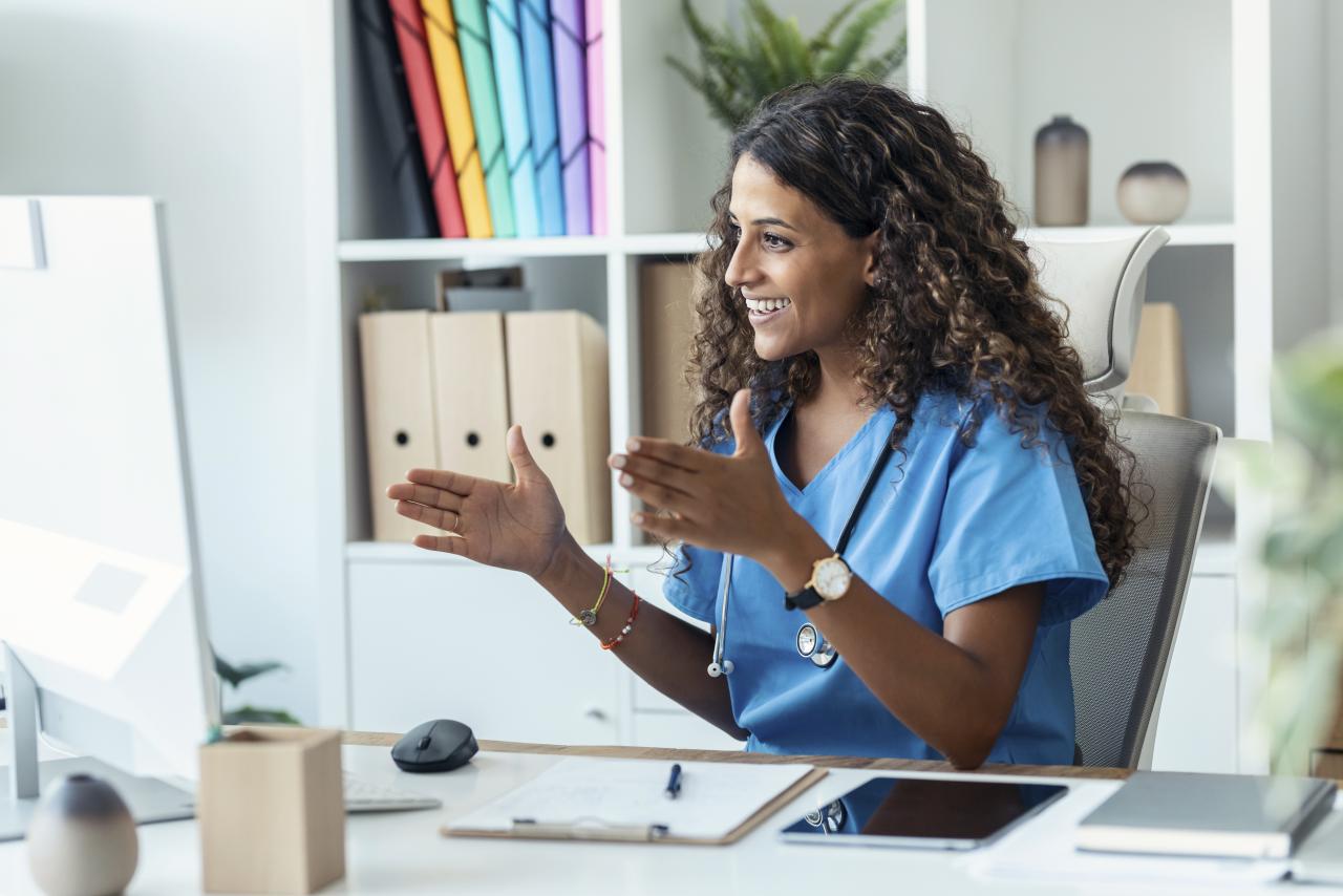 Female nurse explaining medical treatment to patient through a video call