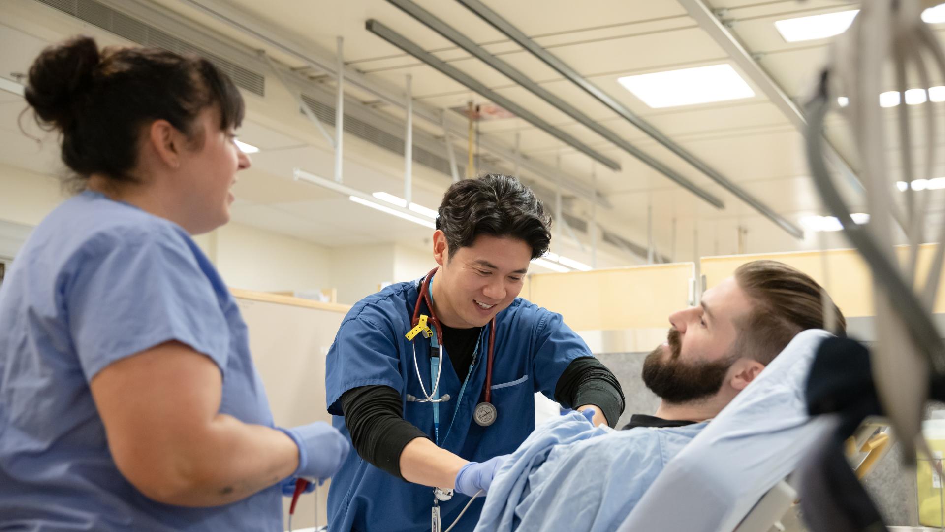 Image of a nurse and doctor assisting a patient 