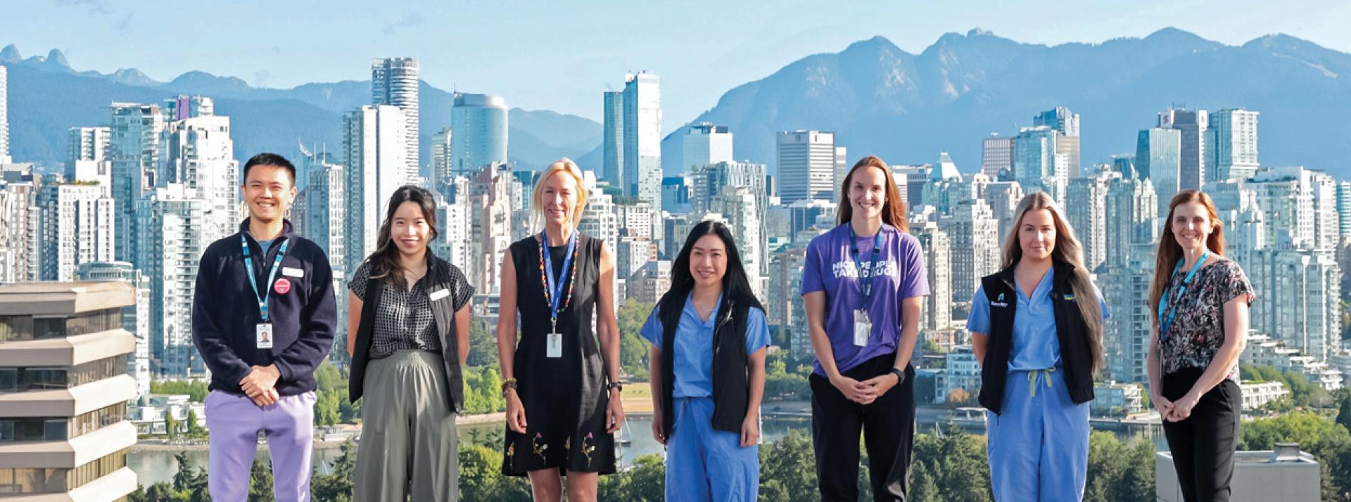 Allied health workers standing in front of the Vancouver skyline