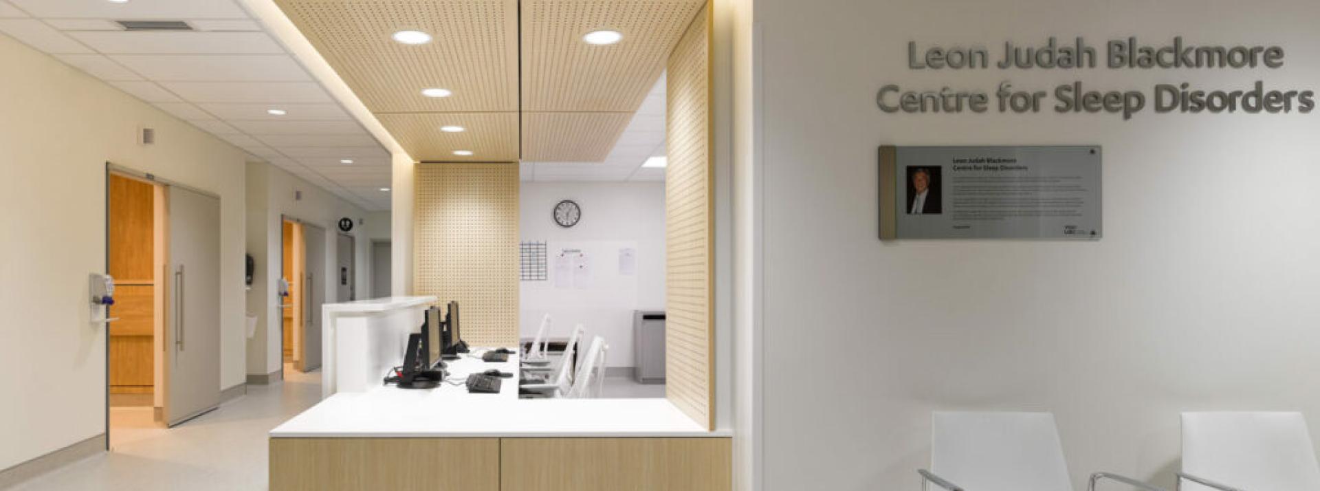 Modern Medical clinic office reception with warm light wooden paneling and white walls 