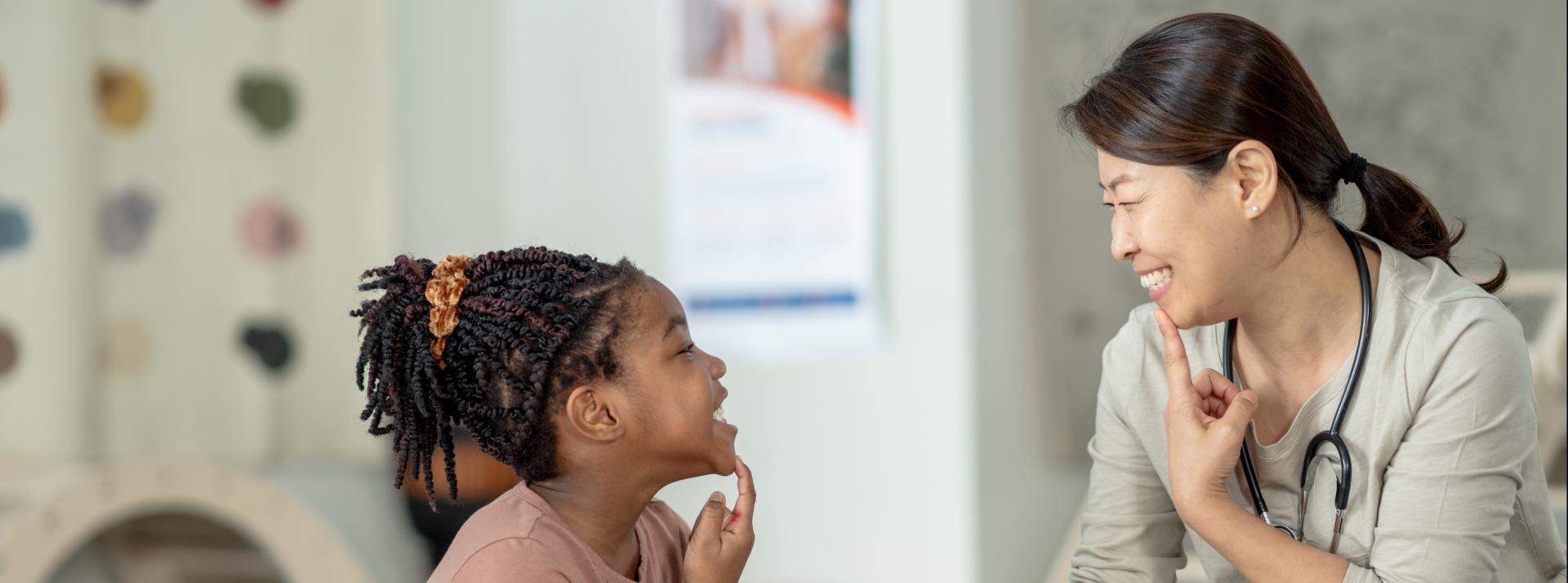 A speech language therapist working with a child.
