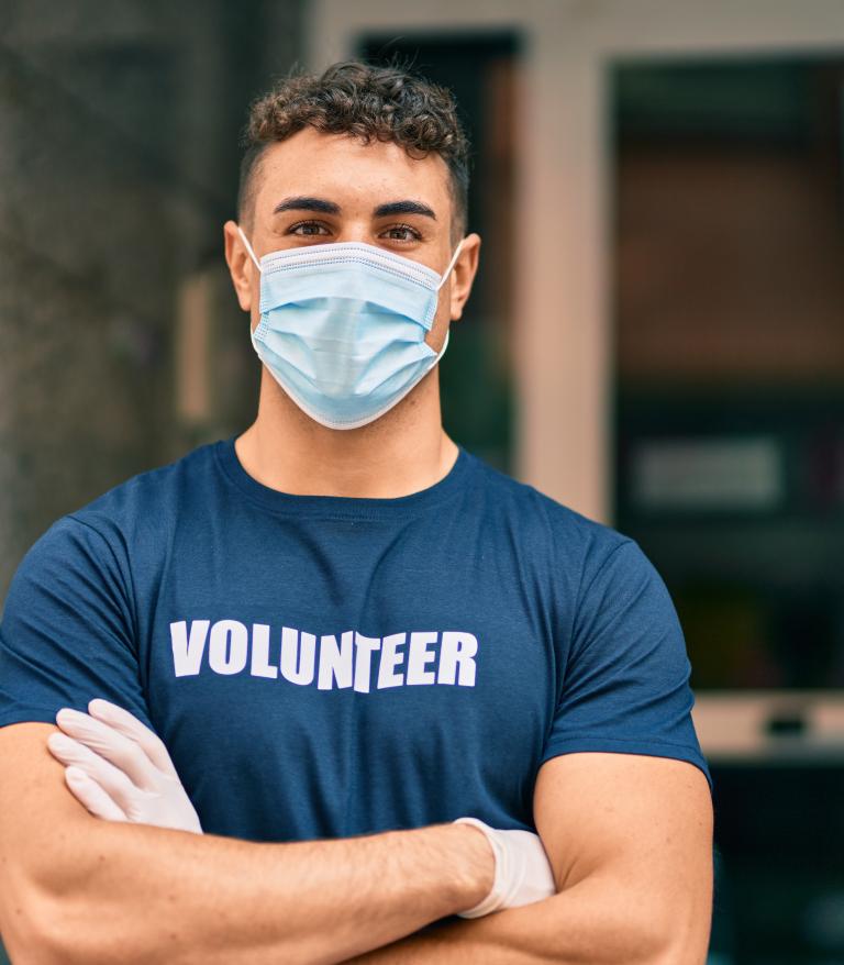 man in mask with volunteer shirt
