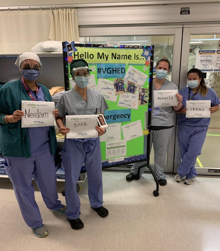 Nurses standing holding hellomynameis signs