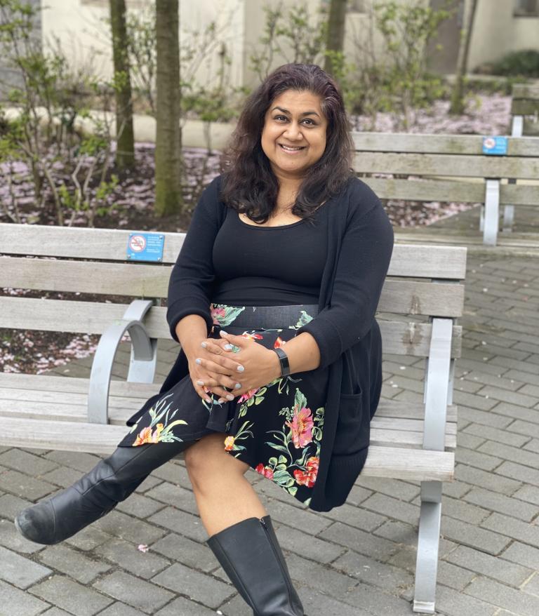 Farinah Kadir, RPN/Mental Health Nurse, sitting on a bench.