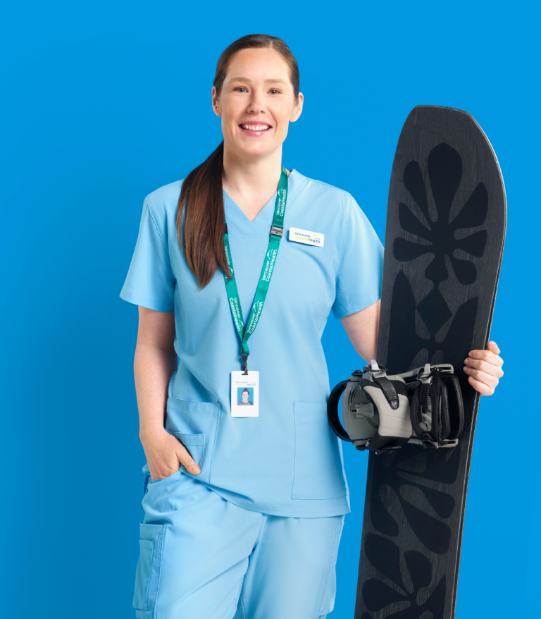Photo of Siobhan, Registered Nurse, holding a snowboard against a blue background