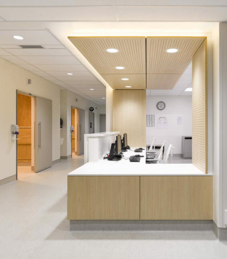 Modern Medical clinic office reception with warm light wooden paneling and white walls 