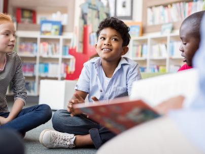 A group of children reading books in a library
