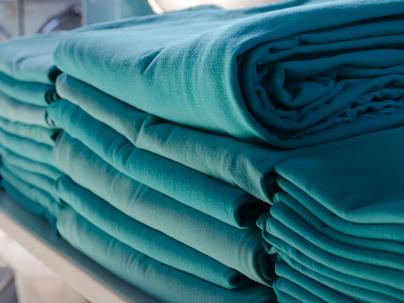 stack of folded hospital laundry 
