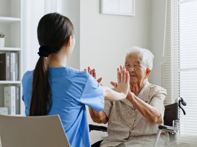 Home nurse talking with senior woman