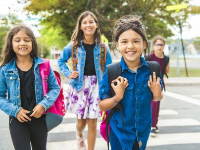 The kids walking to school during the day time