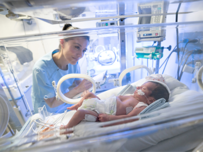 Neonatal nurse with infant