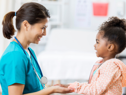 Pediatric nurse with young child