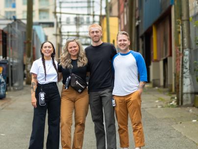 A team of health care workers posing in an alley in the downtown eastside 