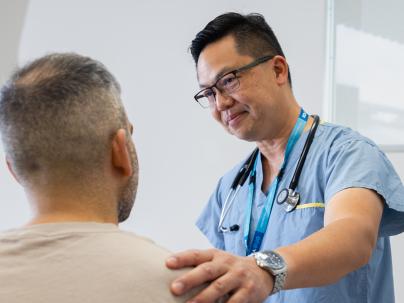 Physician has his hand on patient shoulder 