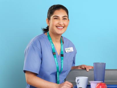 Photo of Ishika, Food Services Worker, against a blue background 